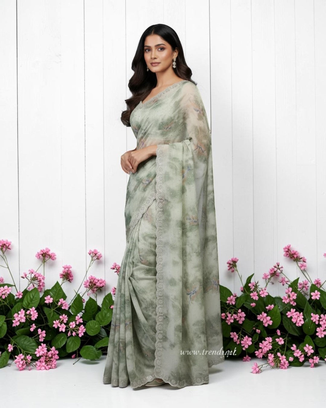 Ethereal sage green floral saree with scalloped stone border