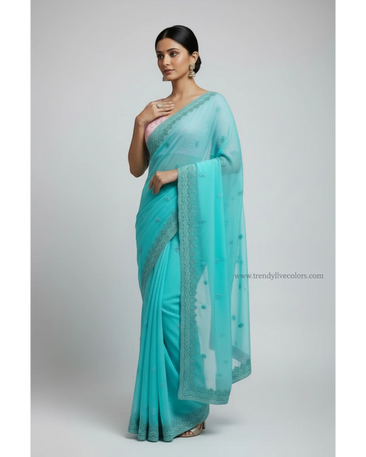Woman in Seafoam Green Embroidered chiffon Saree and Pink Blouse.