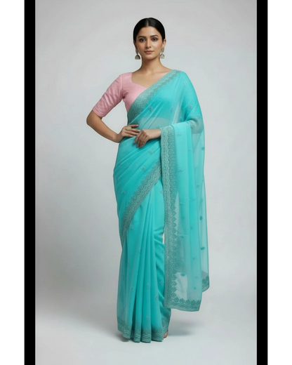 Woman in Seafoam Green Embroidered chiffon Saree and Pink Blouse.