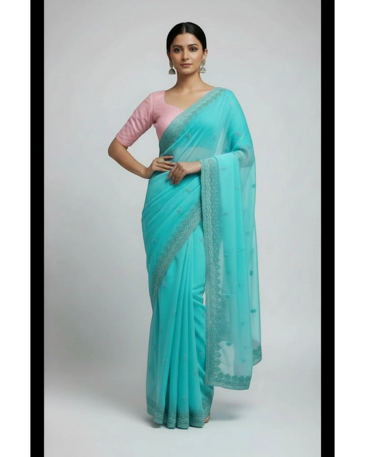 Woman in Seafoam Green Embroidered chiffon Saree and Pink Blouse.